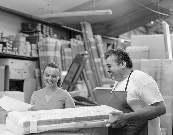 Smiling coworker and woman working while standing at printing factory